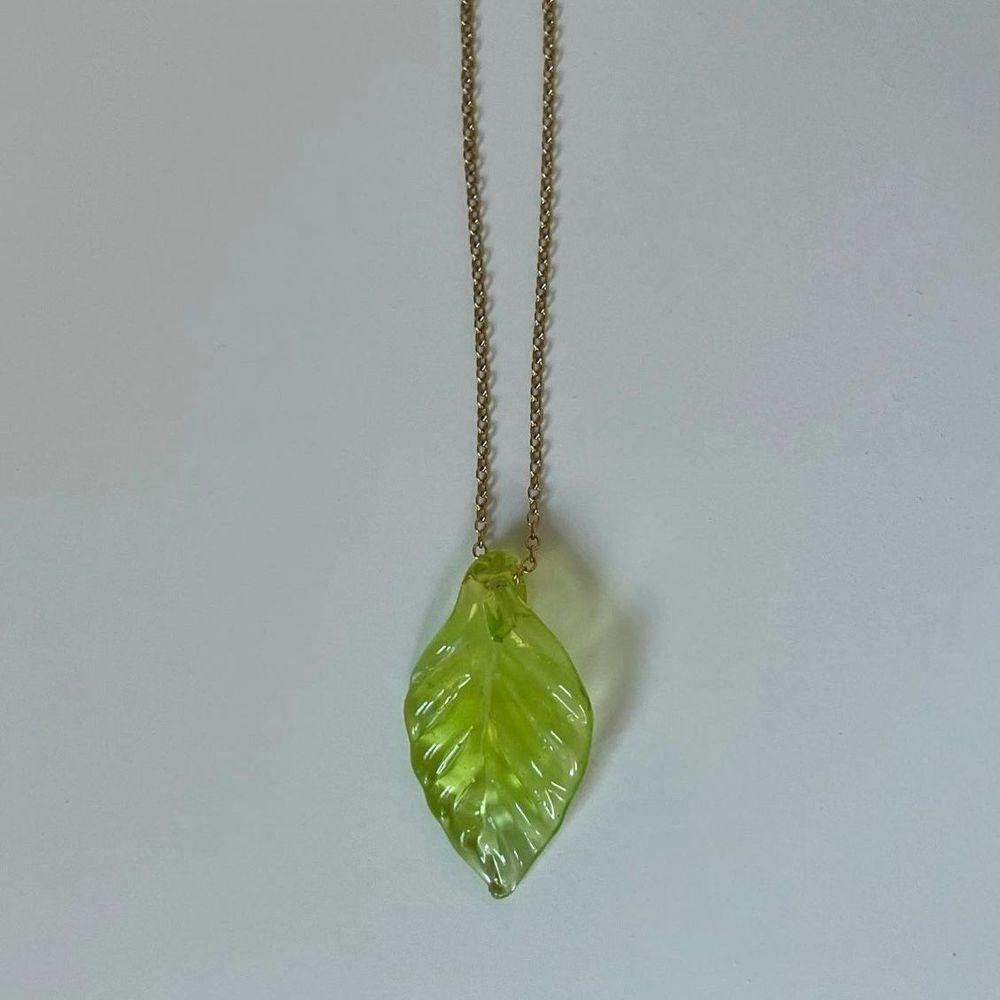 A glass leaf pendant on a necklace